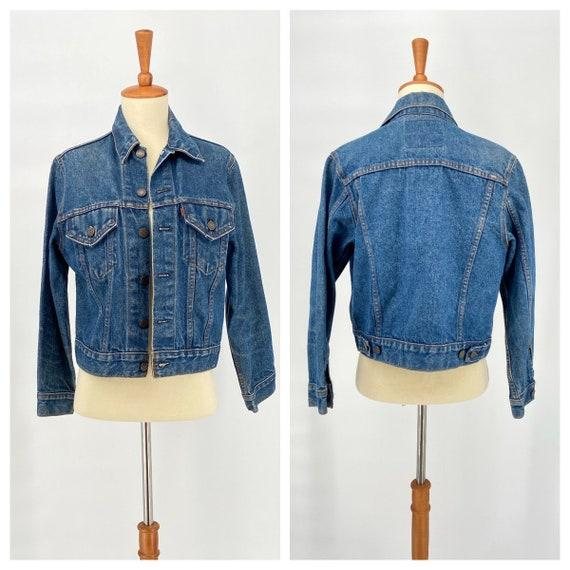 Front and back of a mid-blue pre-loved denim jacket on a mannequin