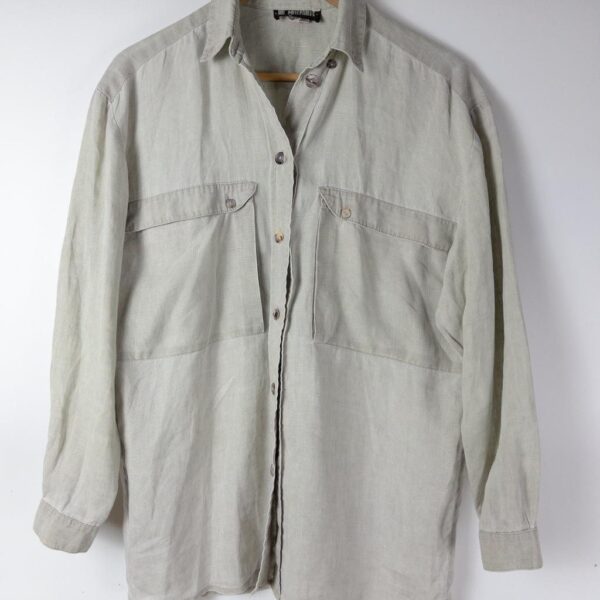 A sage-grey oversized linen-cotton shirt on a wooden hanger