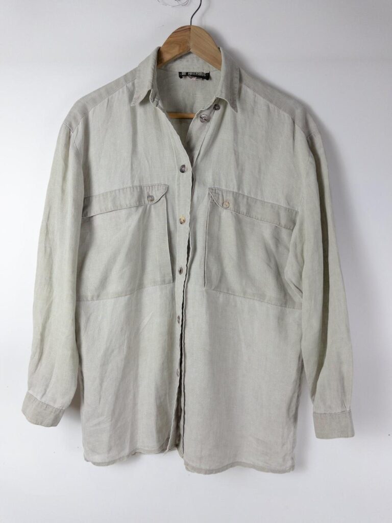 A sage-grey oversized linen-cotton shirt on a wooden hanger