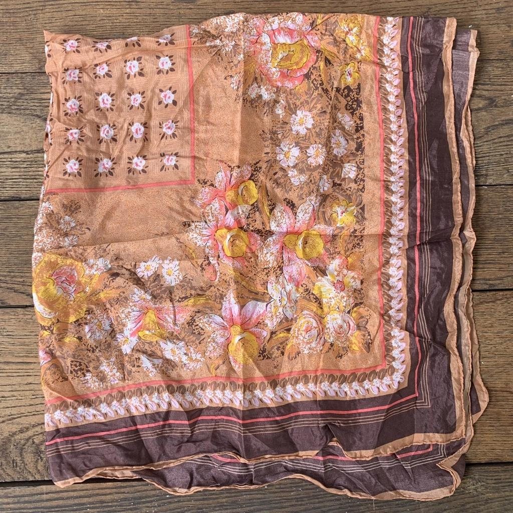 A dusty-pink square scarf with a vintage floral print
